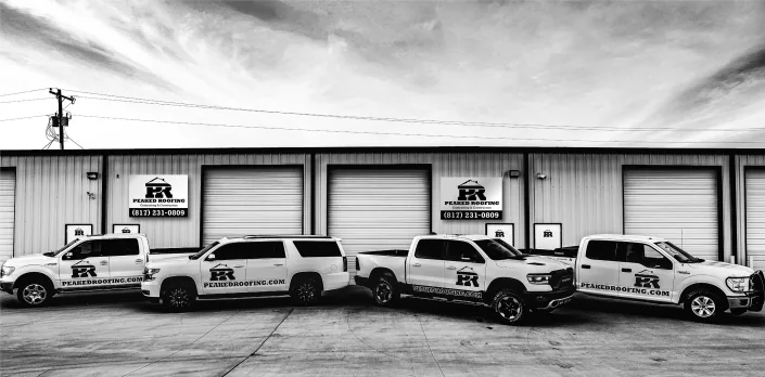 Peaked company vehicles outside the office.