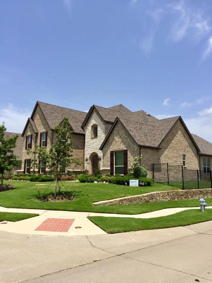 Intersecting rooflines above a stone home.